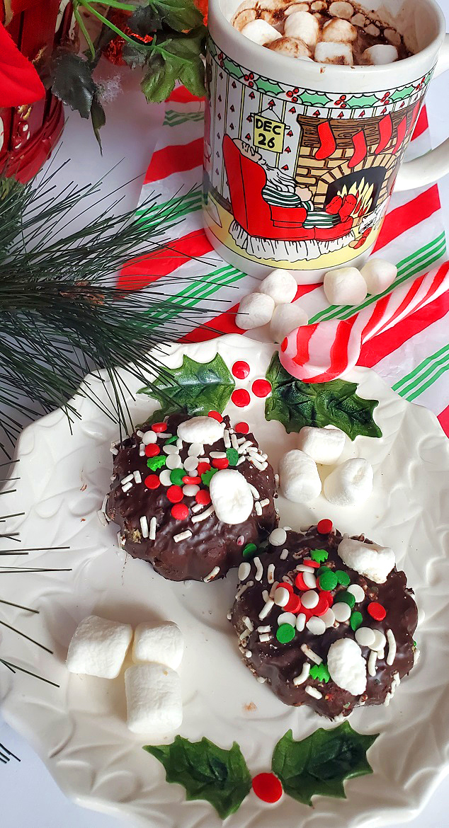 cookies with marshmallows on  top on Christmas plate and peppermint spoon