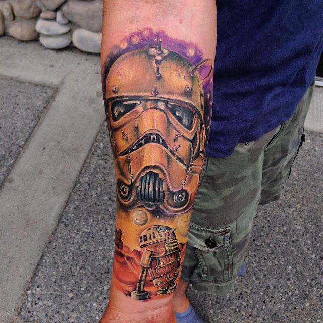 sleeve arm tattoo of star wars stormtrooper head and R2D2 robot