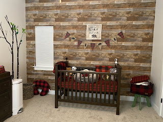 do not wake the bear sign - photo of crib with faux wood planks in nursery cabin theme buffalo plaid