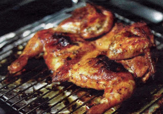 Chicken-piri piri, spatchcocked chicken cooking on a barbecue