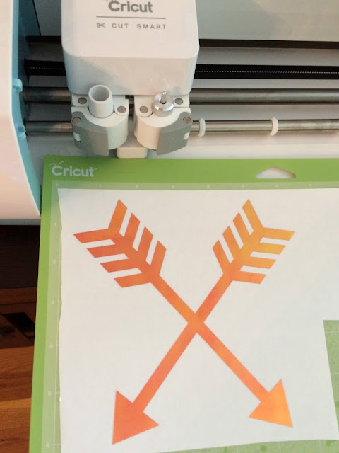 Make a plain wooden tray fancy with paint and holographic vinyl arrows using a Cricut.