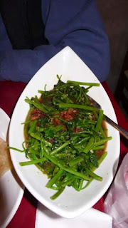 Image of stir-fried vegetables (a morning glory variety, allowing savoury revenge for gardeners) with a fermented shrimp paste at Pasar restaurant in Hong Kong.