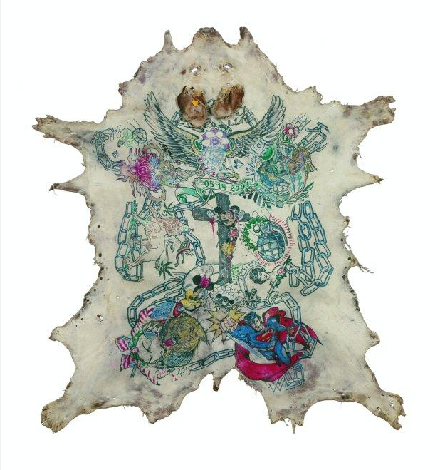 The tattooed pig skin pieces below are at the Galerie Emmanuel Perrotin in 
