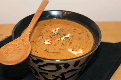 Spoon with bowl of soup.