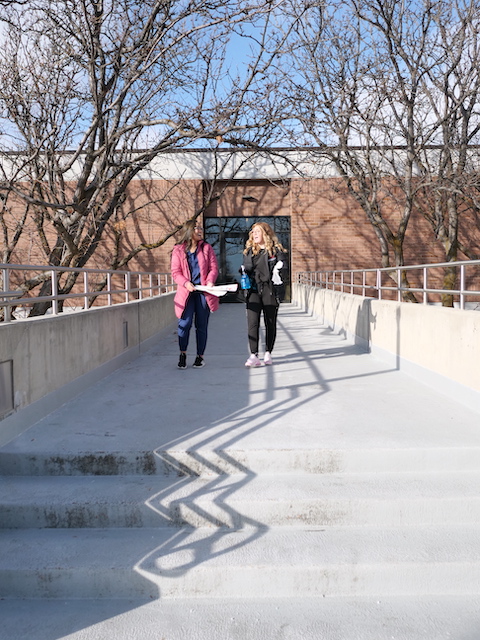 Dental Hygiene students walking in front of the Constructions Trade Building