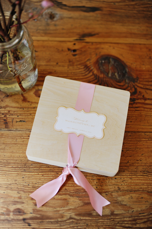  a paper gift bag and filling it with snacks and a wedding itinerary