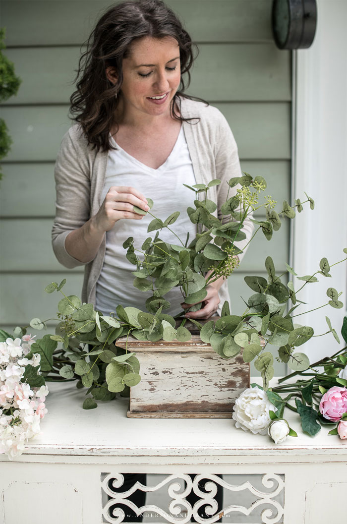 Adding eucalyptus to the white box for flower arrangement