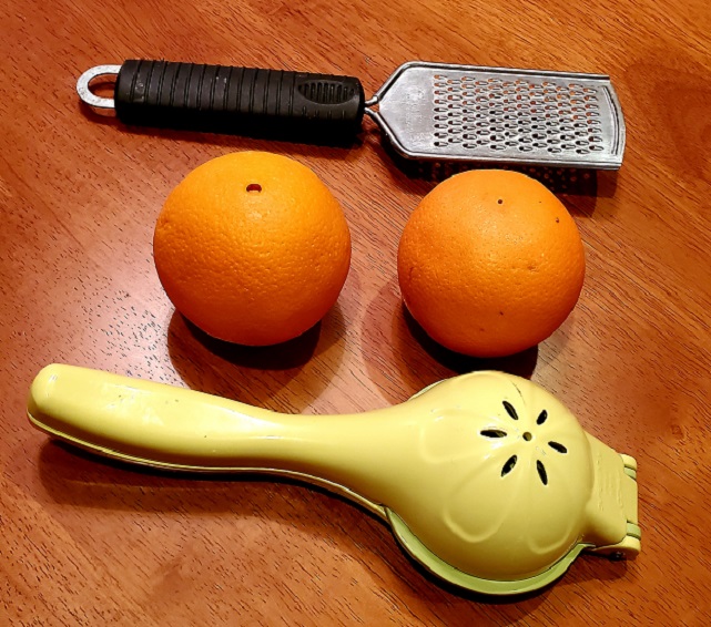 fresh oranges with juicer and grater