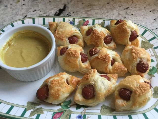 Parmesan Crusted Pigs-in-a-blanket served with honey mustard