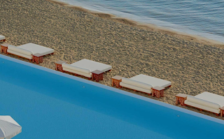 Sunbeds on the beach at hotels Porto Heli