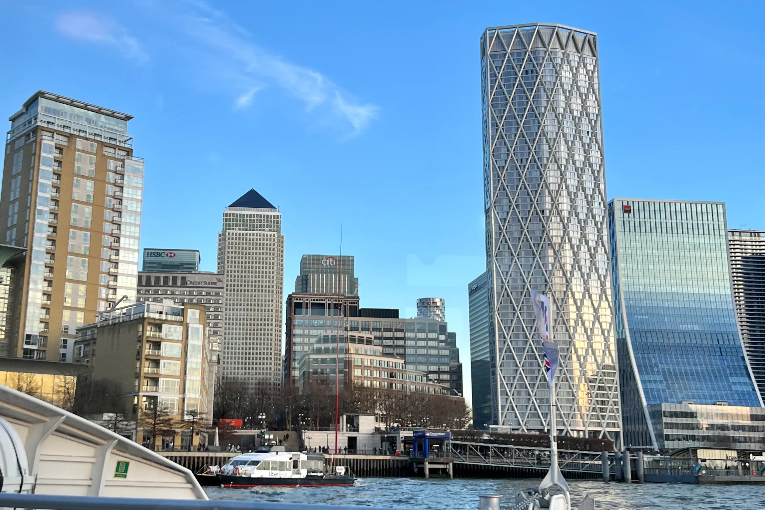 A view of the tall buildings of Canary Wharf in London from a river bus