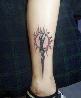 sun and lightning tattoo on the leg