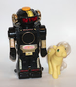 [Image: A plastic robot toy standing next to a My Little Pony.]