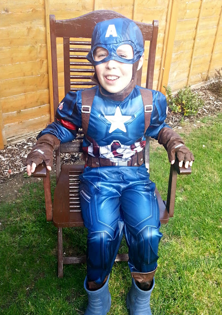 Boy wearing Captain America Costume Seated