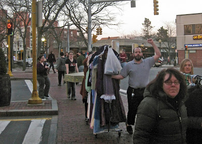 The cast and crew of Pride & Prejudice move set and costumes through Davis Square.