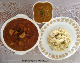 Spicy white soft rice with vegetables and coconut milk for breakfast with potato curry and sambol