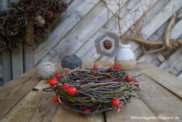 Herbstnest mit Hagebutten und Kastanien