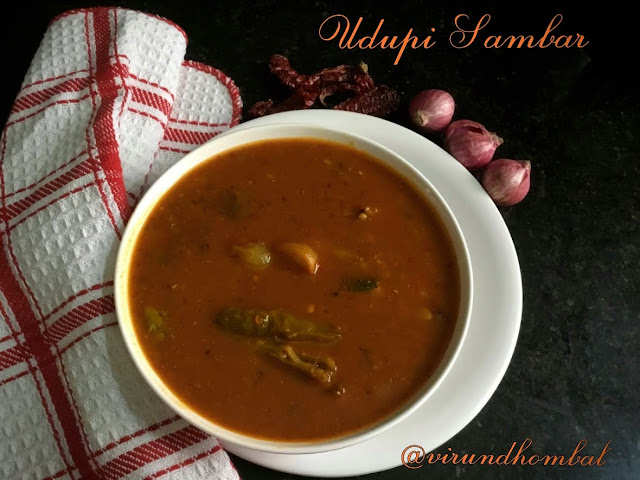 Udupi Sambar for Idly and Dosa - Udupi Sambar with step by step photos- Udupi Sambar - colourful and flavourful sambar for idly, dosa and vada. Udupi Sambar is prepared with the same spices and vegetables we add for tiffin sambar but we use bydagi chillies which give a deep red colour for the sambar. Bydagi chillies are roasted along with our regular spices like coriander, cumin, chana dal and fenugreek and then ground it to a smooth paste. The bydagi chillies are also known as Kashmiri chilli and are available in all supermarkets. This bydagi chilly is a less hot than a regular long chilly. So if you want a less spicy sambar for tiffin, choose this Udupi Sambar. The secret to getting the sambar to a smooth consistency with a deep red colour is we have to add the ground paste as soon as the vegetables are done and boil them slow and long so they cook perfectly. The slow cooking method helps to blend well with the vegetables. Then we have to add the cooked toor dal and jaggery. For Udupi Sambar I prefer drumsticks, brinjal, small onions and tomatoes. You can also include potato, carrot, beans, etc. Now we will see how to prepare Udupi Sambar with step by step instructions.