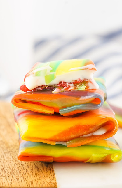 Stack of Ice Cream Fruit Roll Ups on a wooden board.