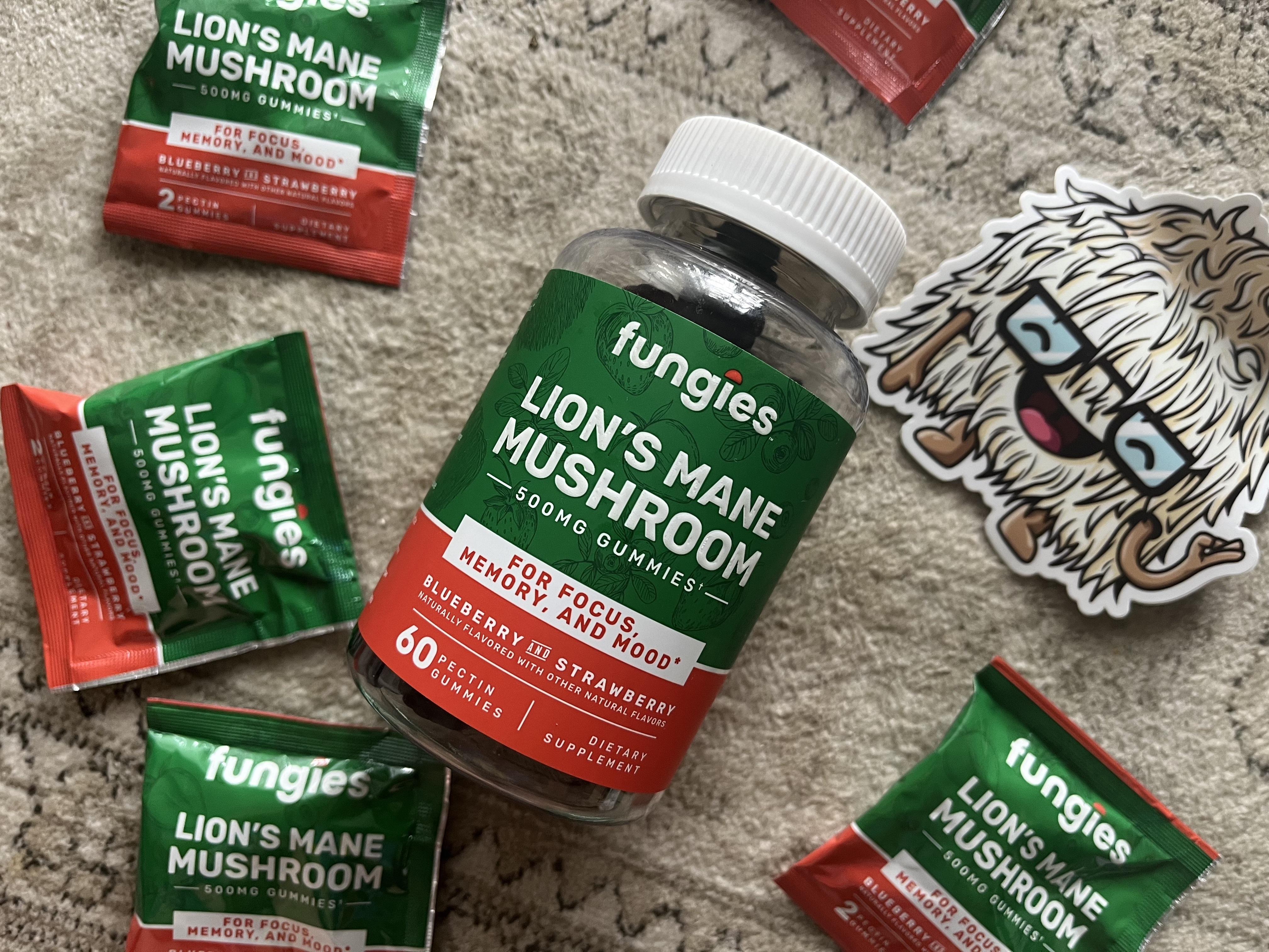 Photo of a bottle of Fungies Lion's Mane Mushroom Gummies with a few additional Fungies packets and a sticker of an cute drawn lion's mane mushroom Small Business Gift Guide  Carmen Varner