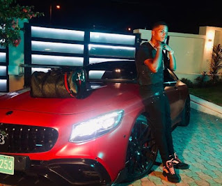 Leon Bailey posing for the picture with the car