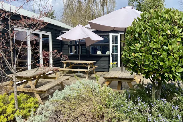 Picnic tables in an outdoor eating area at Lathcoats Farm