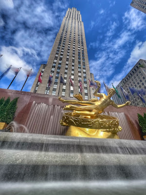 Prometheus statue low angle Rockefeller center building rising in background