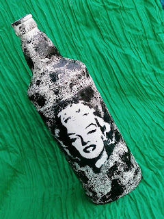 This ucpcyled bottle has image of Marlyn Monroe decoupaged on it and the textured created with gesso and acrylic color. 