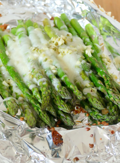 This side dish is simple to make on the grill or in the oven! It combines easy ingredients like asparagus, cheese, garlic, butter and seasonings for a mouthwatering side to go with chicken, beef, fish, seafood or pork! Great as a meatless meal too!