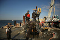 Building a new sea wall in the Queens borough of New York City, one year after Hurricane Sandy devastated much of the area with severe flooding and wind damage. (Credit: Spencer Platt/Getty Images) Click to Enlarge.