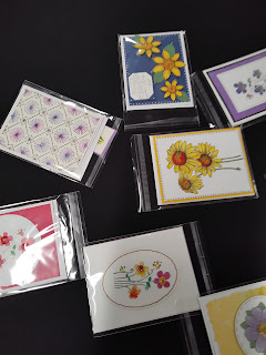 Assorted note cards decorated with coloring, sewing, and tatting