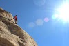 Man climbing sloping mountain