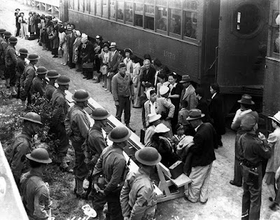 Americans are herded onto trains and taken away from their homes.