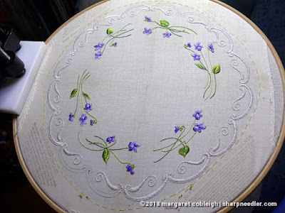 A nearly completed centrepiece with all the violets done and just a bit more edge to embroider. (Society Silk Violets)