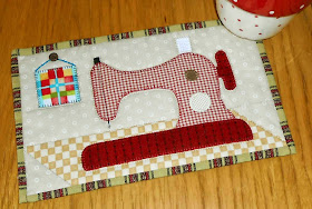 http://www.craftsy.com/pattern/quilting/home-decor/sewing-machine-mug-rug/94623