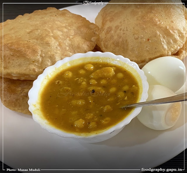 Homemade Puri and Ghuguni with boiled egg for morning breakfast of Manas Muduli