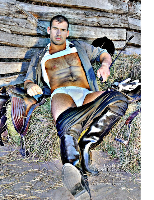 darryl dominguez in riding costume lying back pants on his knees shirt under his chin showing his hairy body
