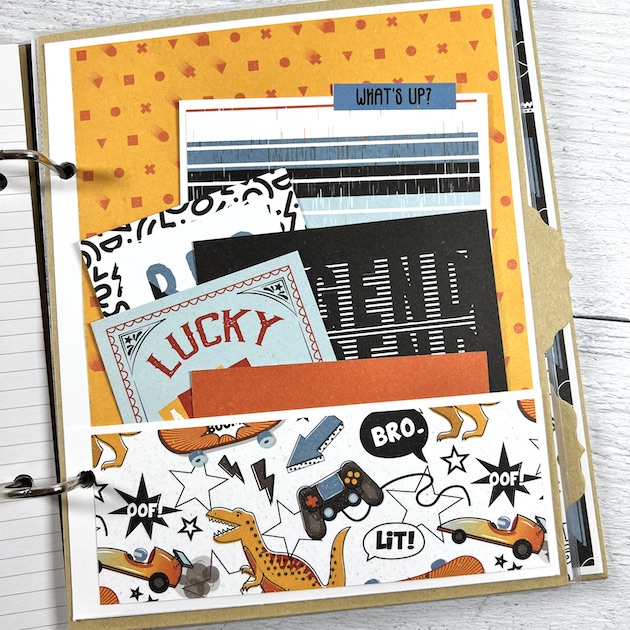 Boy Scrapbook Album page with a pocket, journaling cards, skateboards, race cars, dinosaurs, and a video game controller