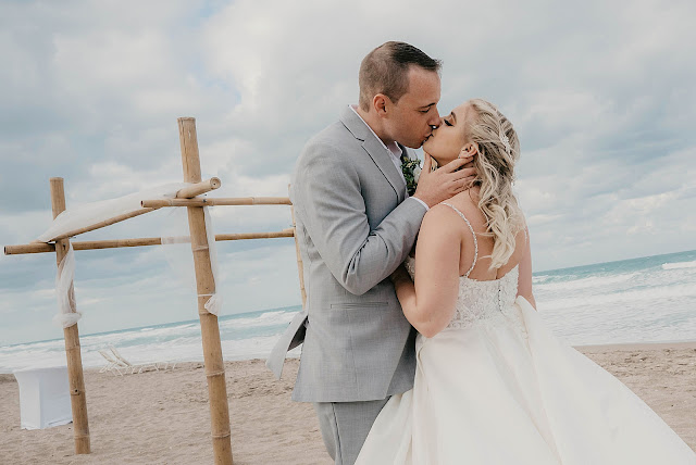 Bride and Groom kissing on the beach