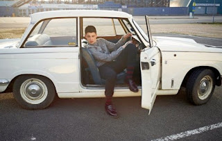 Ash Stymest posing for picture while sitting inside the car