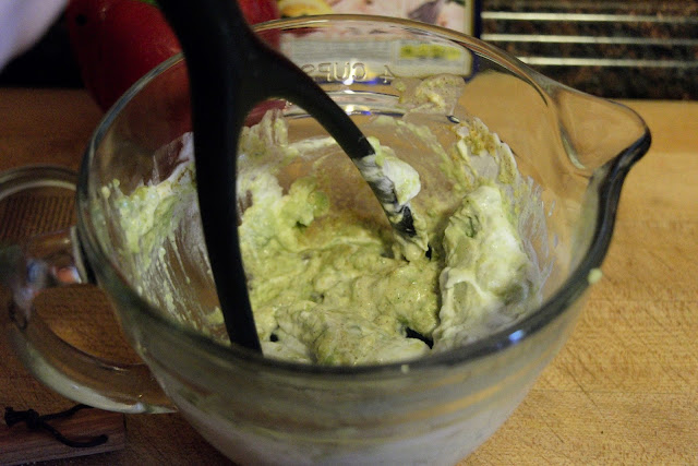 A picture of a potato masher mixing the dressing of the tuna salad together. 