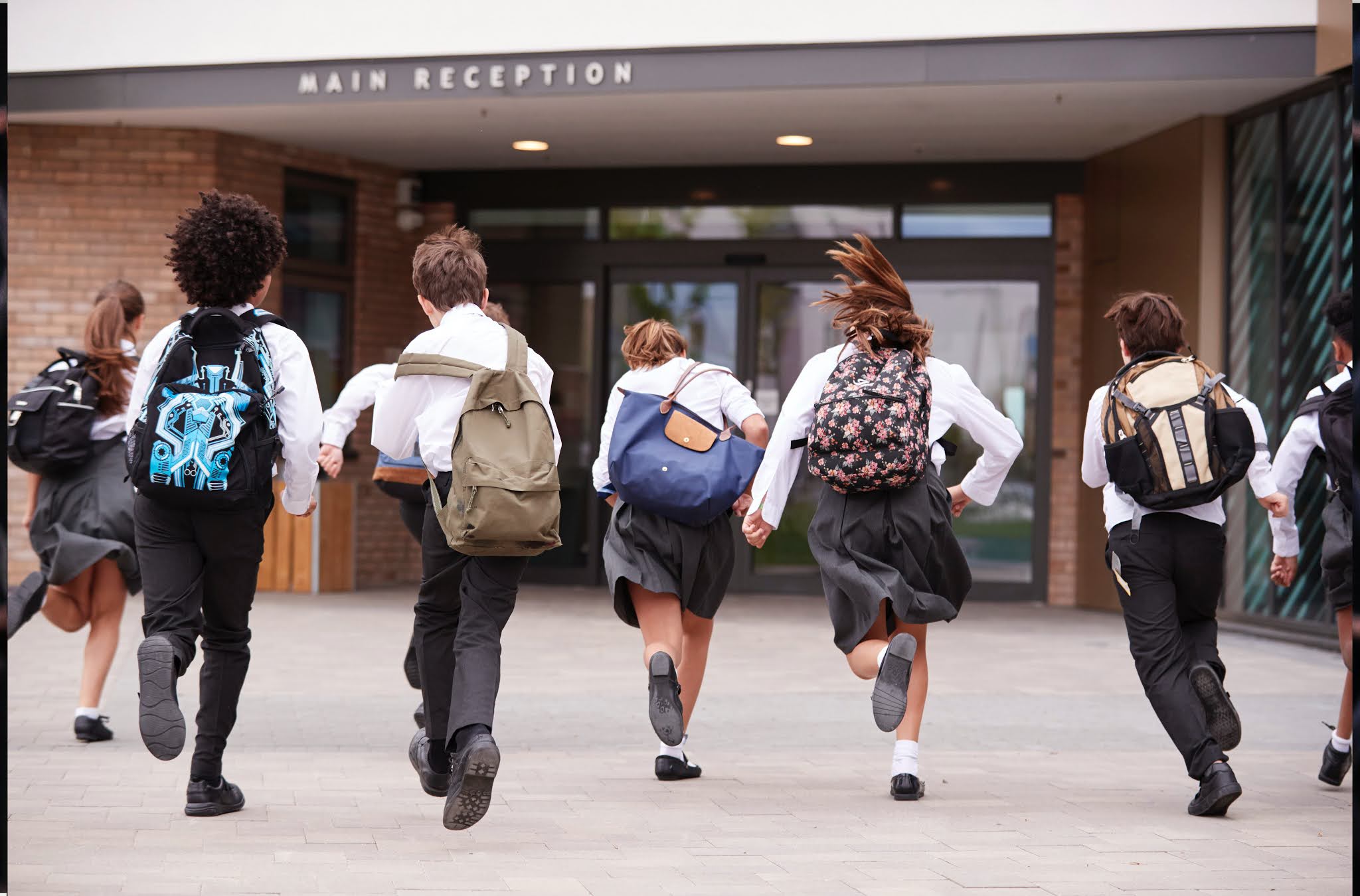 children running in to school