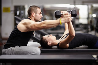 woman working with a personal trainer