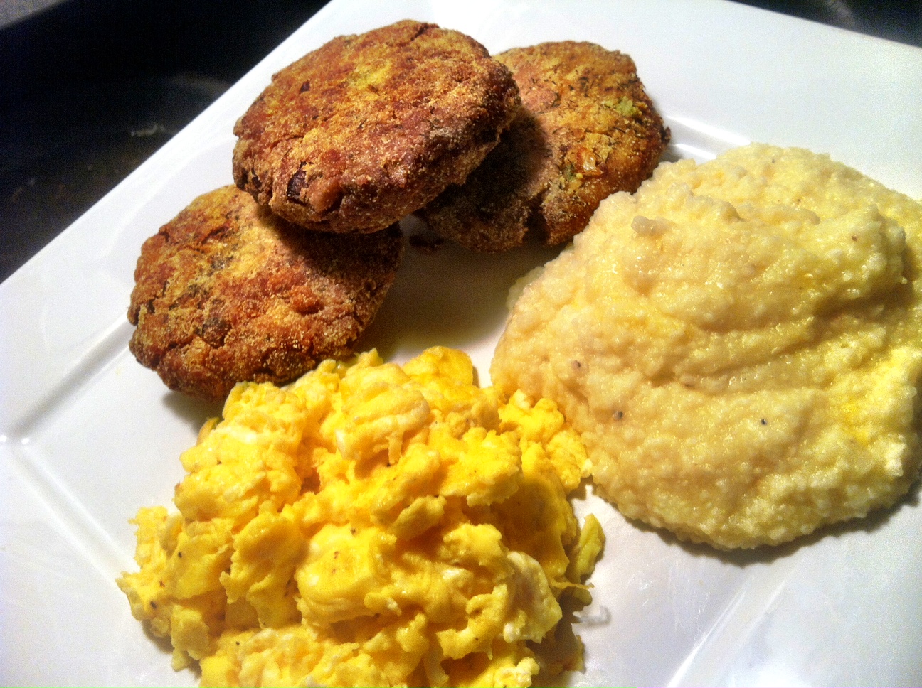 Salmon croquettes with scrambled eggs and cheese grits