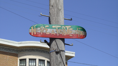 back of skateboard painted with message - here a taste of italy