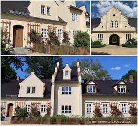 Champagne coloured Dutch style gabled houses decorated with red roses.