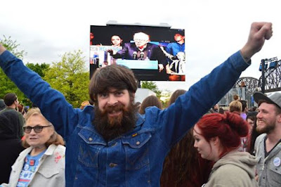 Louisville Bernie Sanders Rally jean jacket arms raised in victory triumph