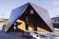 Origami House Design with A-Frame in an Old Village Surrounded by Mountains