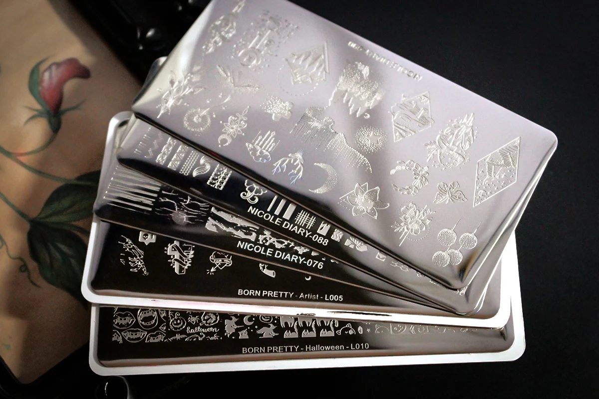 an aesthetic close-up of a stainless steel nail stamping plate with spooky halloween pattern