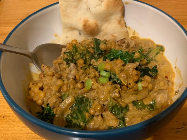 Pork and lentil curry, with kale and naan bread